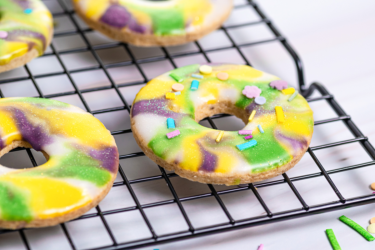 close up of glitter king cake cookies with sprinkles 