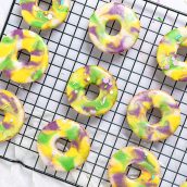 frosted king cake cookies on a wire rack