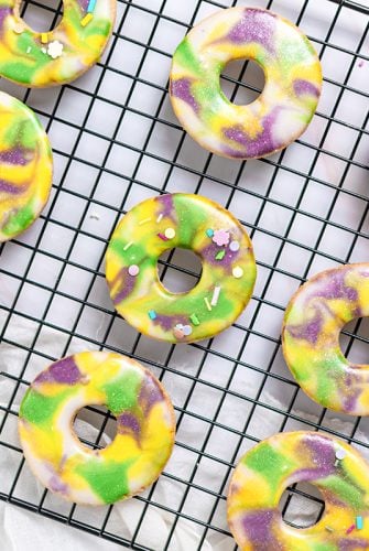 frosted king cake cookies on a wire rack