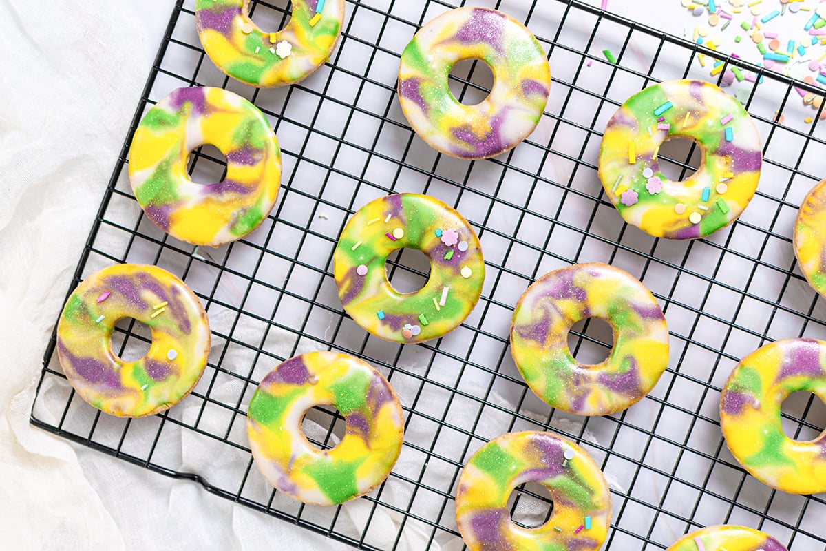 frosted king cake cookies on a wire rack