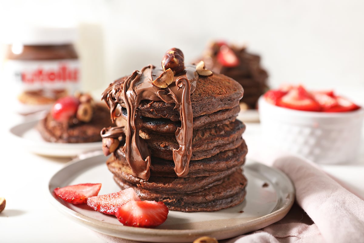 stack of nutella pancakes with strawberries