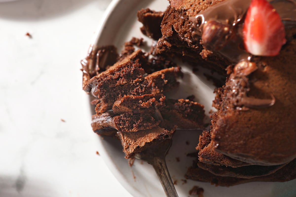 large bite of brown pancakes on a fork 