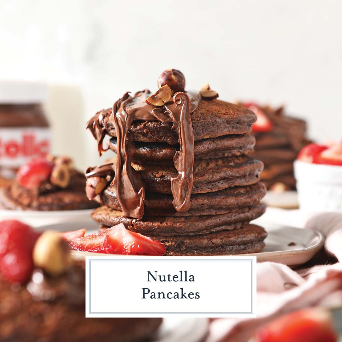 stack of nutella pancakes with hazelnuts and strawberries 