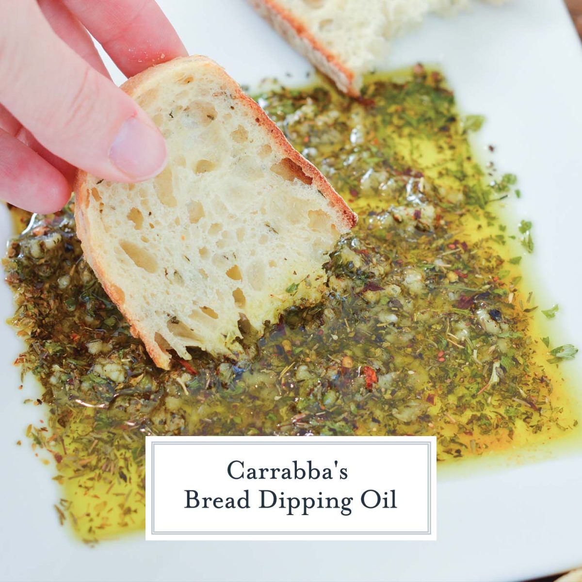 slice of crusty bread dipping into bread dipping oil 
