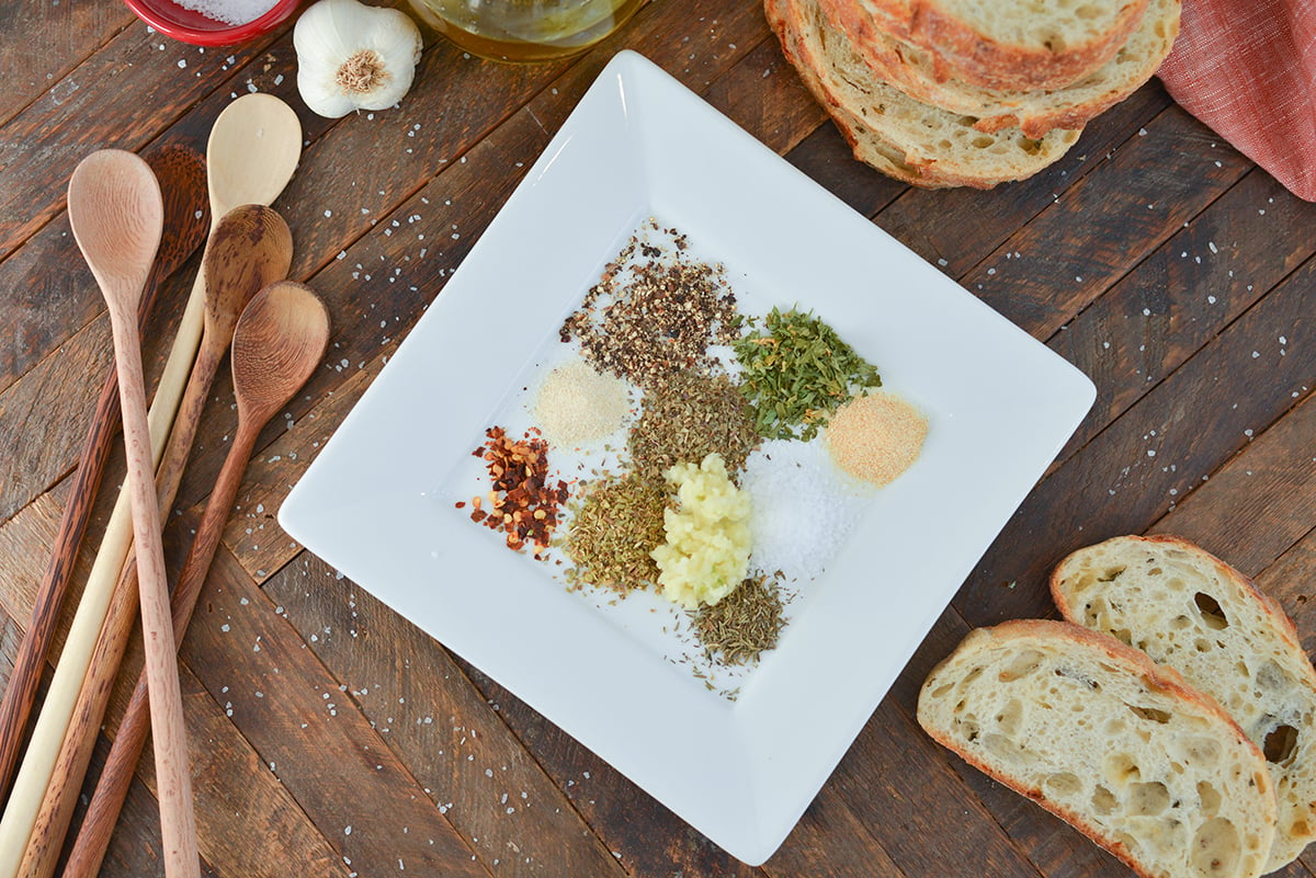 overhead of dry spices on a white plate 