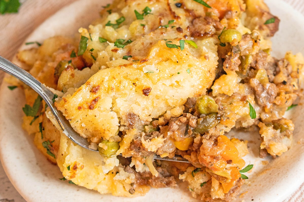 fork in a shepherd's pie on a serving dish 