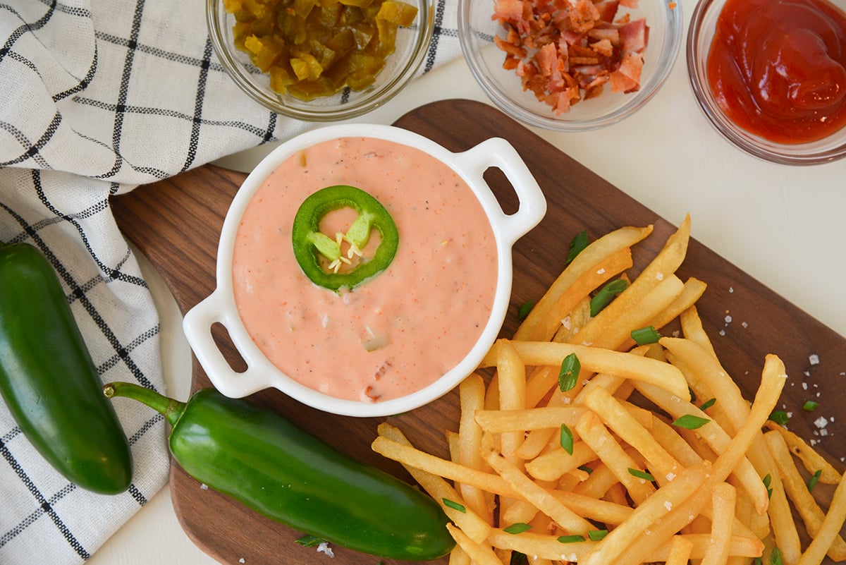overhead of fry sauce with fresh jalapenos and french fries 