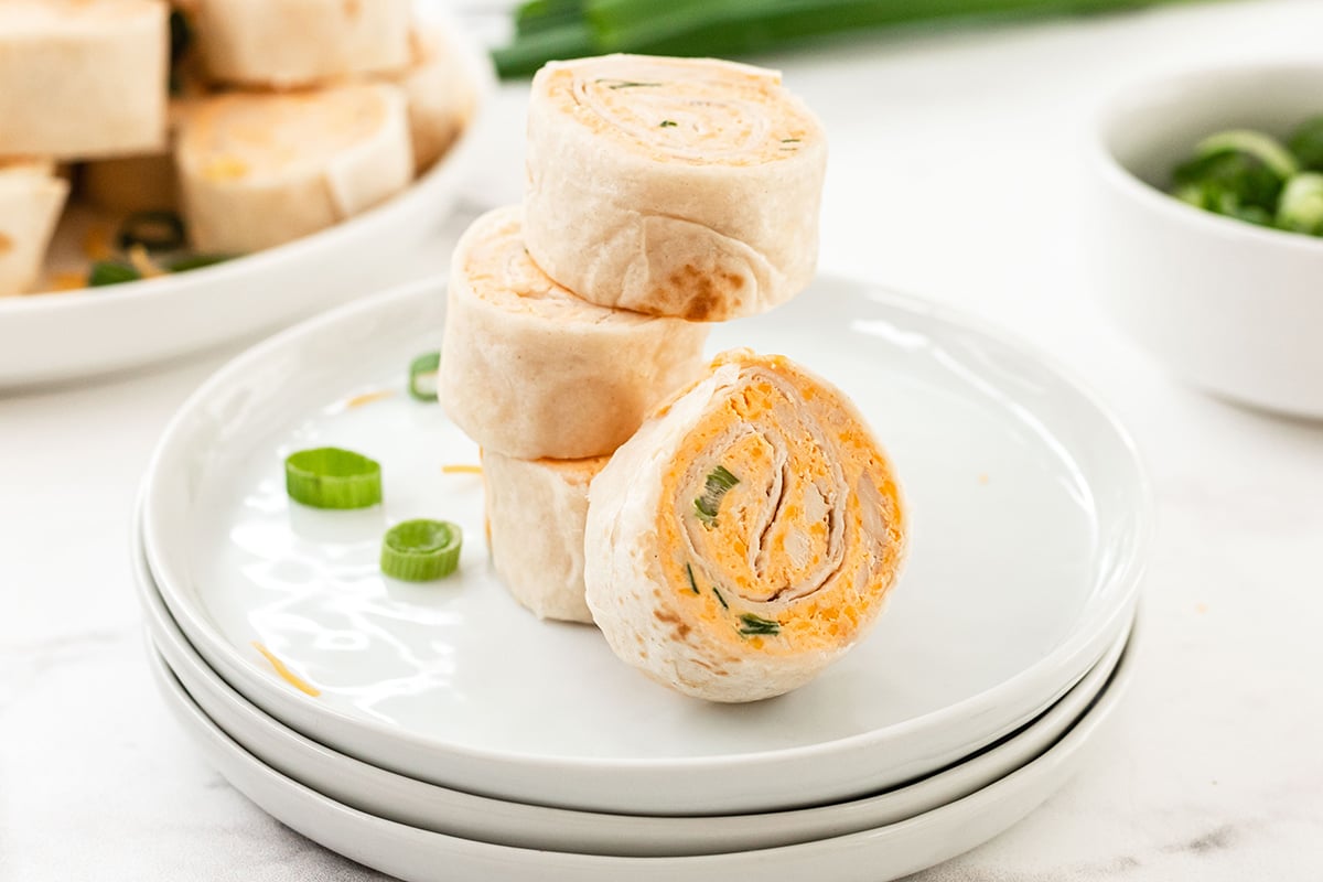 stack of buffalo chicken pinwheels on a small appetizer plate 