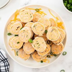 overhead of buffalo chicken pinwheels on a serving platter