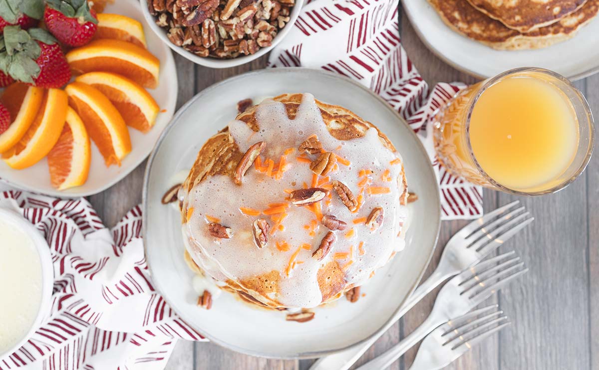 overhead of carrot cake pancakes with breakfast spread 