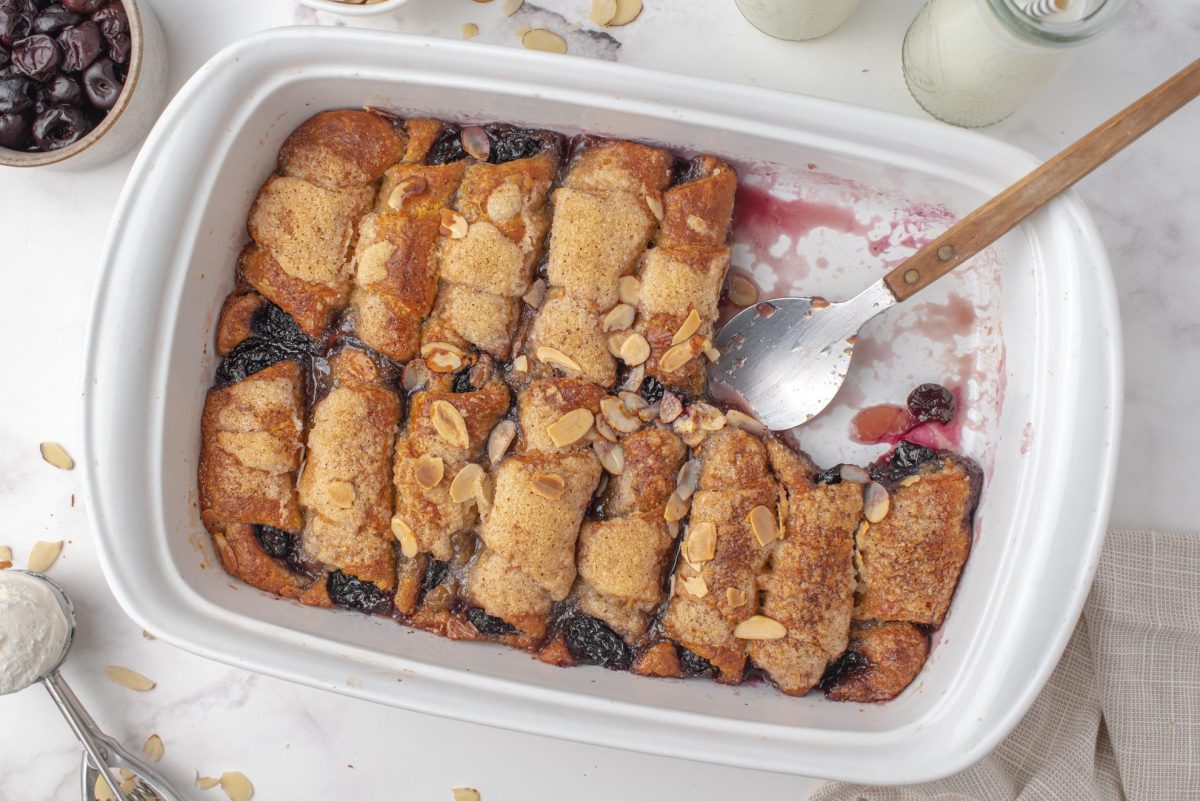 Spoon in baking dish of cherry dumpling casserole