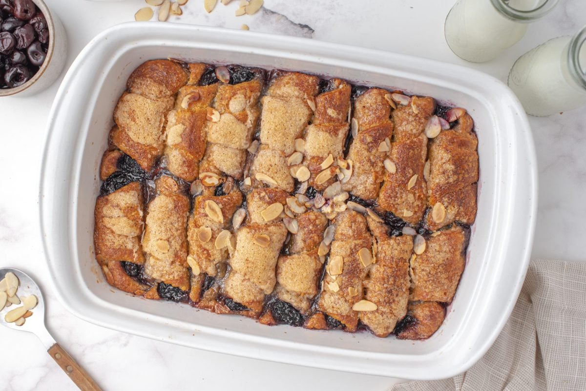 Overhead shot of baked cherry dumpling casserole in a white baking dish