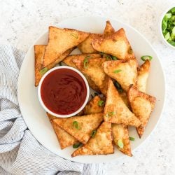 plate of crab rangoons with sauce