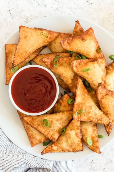 plate of crab rangoons with sauce