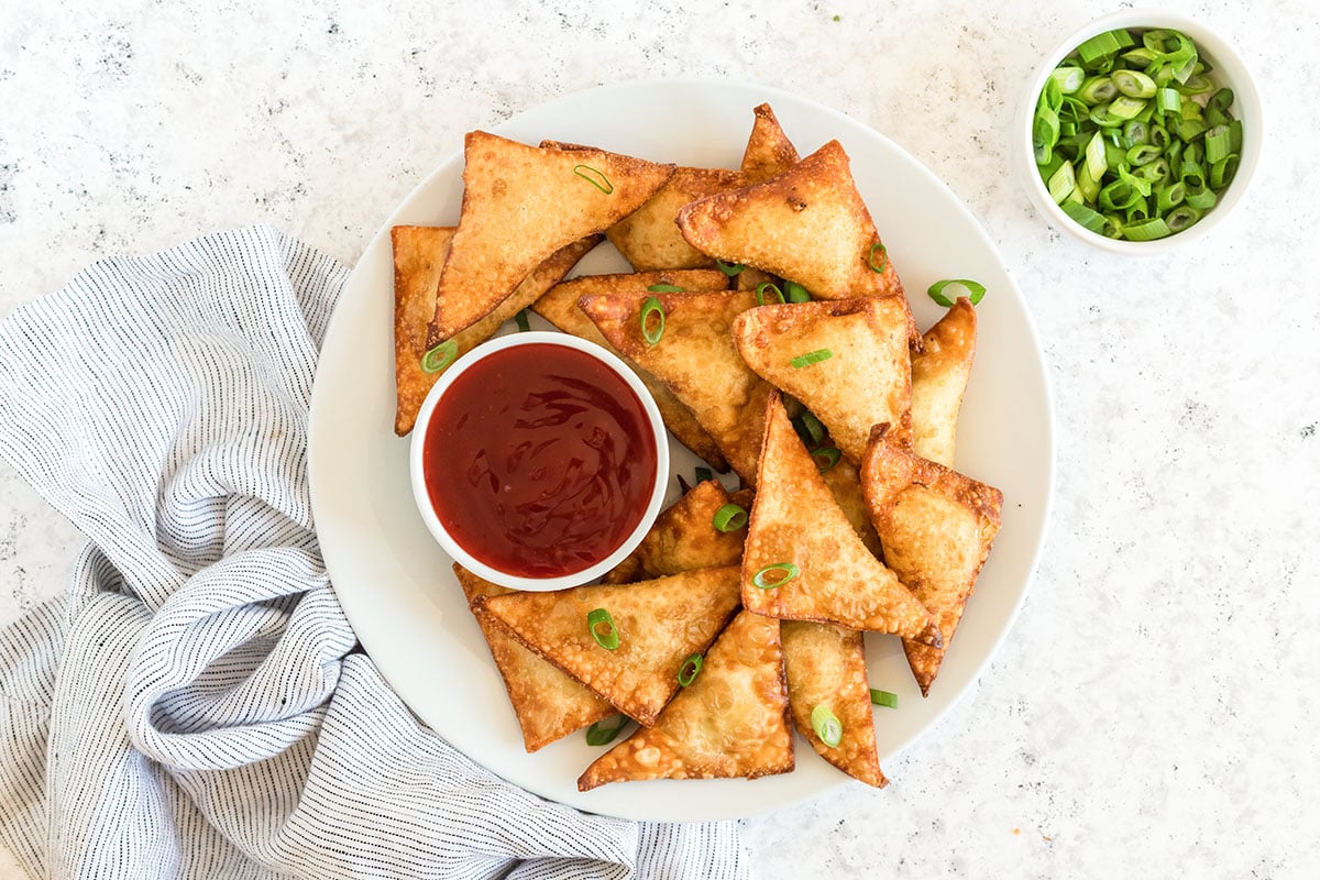 plate of crab rangoons with sauce