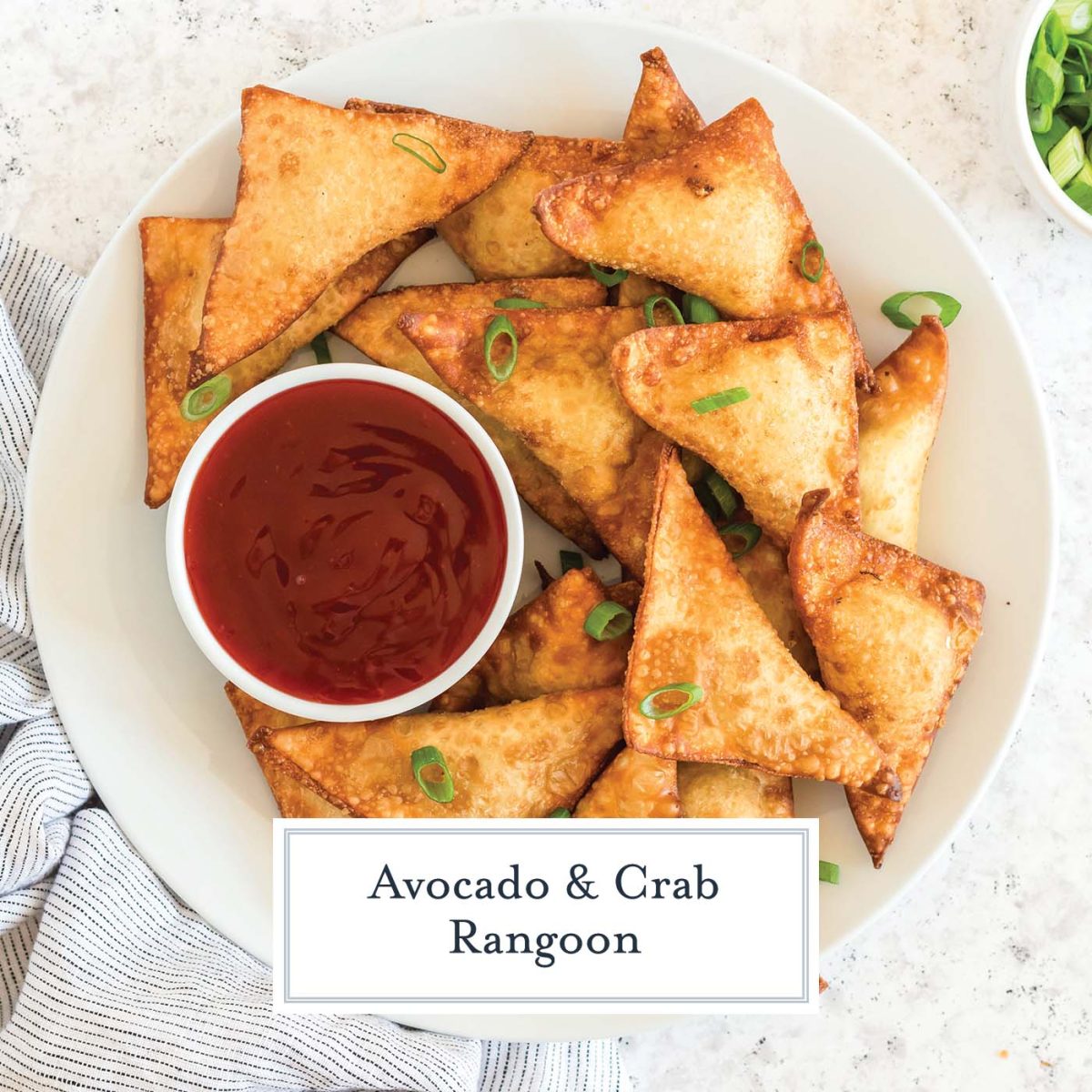 overhead of plated crab rangoons with sweet and sour dipping sauce