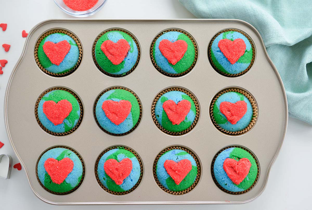 twelve earth day cupcakes in a muffin tin 