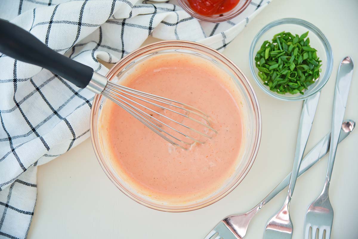 fry sauce in a glass bowl with a whisk 