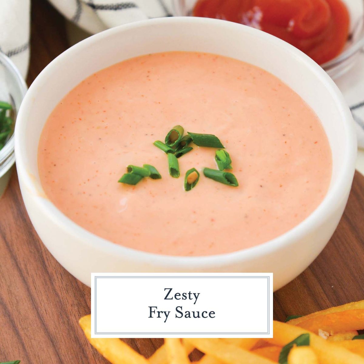 close up of fry sauce in a white bowl with chive topping