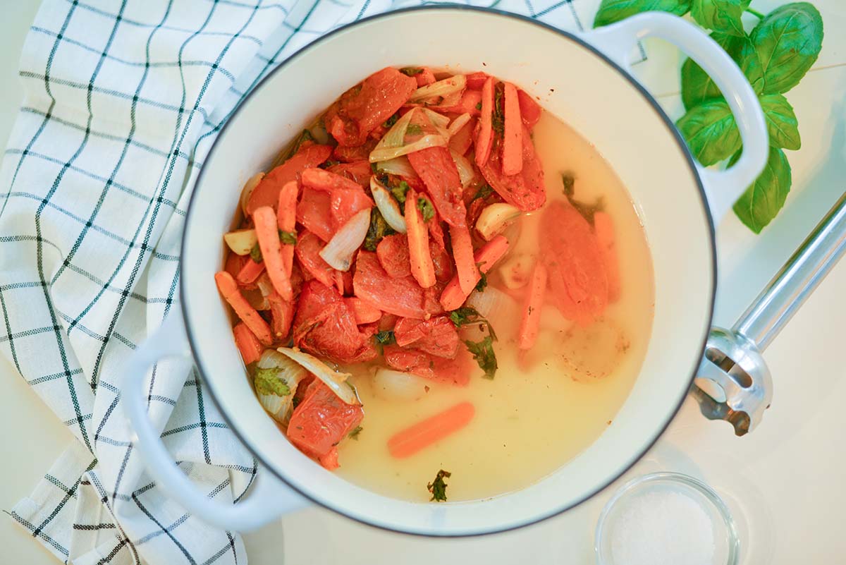 roasted vegetable and broth in a large cooking pot 