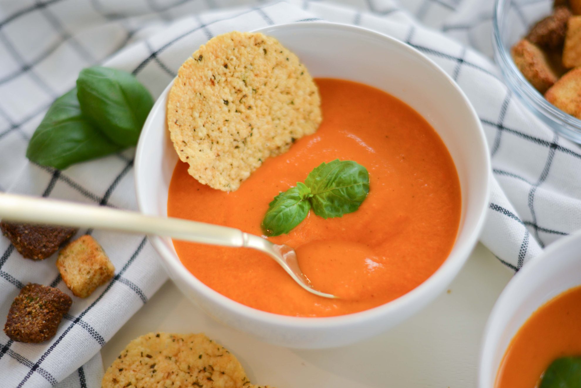 overhead shot of spoon in bowl of tomato bisque