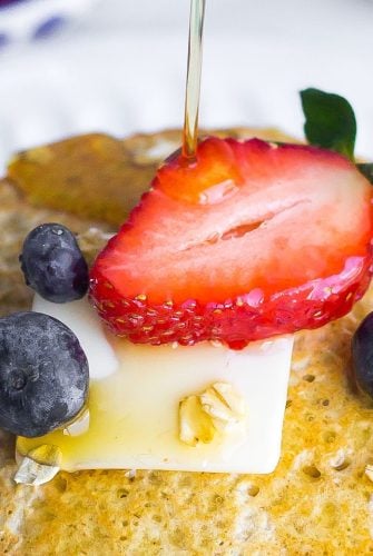 oatmeal pancakes drizzled with maple syrup and fresh fruit