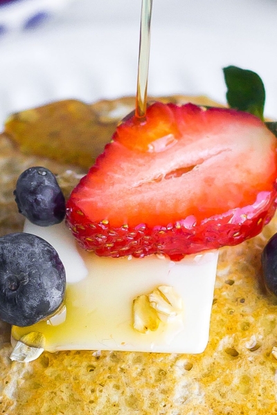 oatmeal pancakes drizzled with maple syrup and fresh fruit