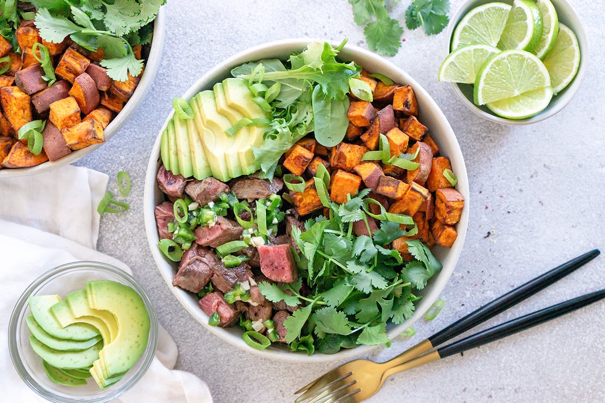 overhead of southwestern steak bowl with avocado