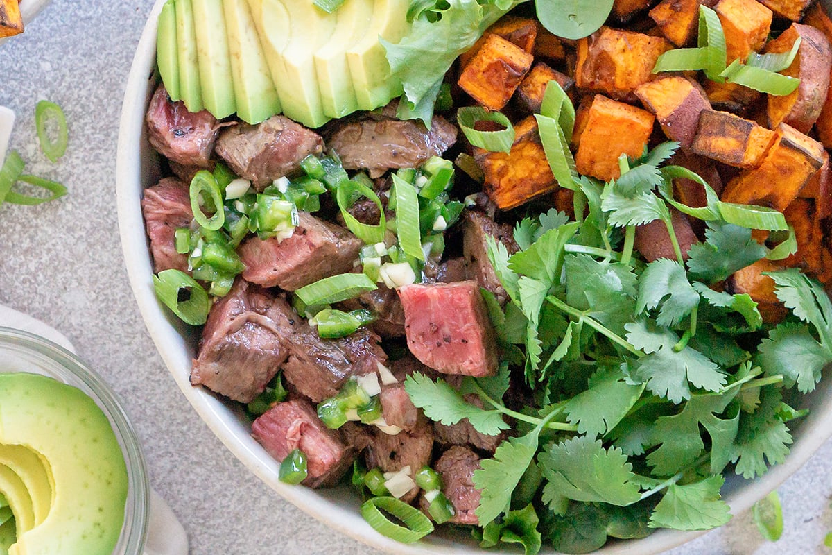 close up of chopped rare beef in a salad 