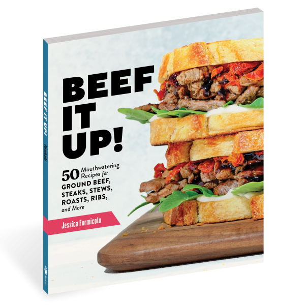 cover of a cookbook with a steak sandwich called beef it up
