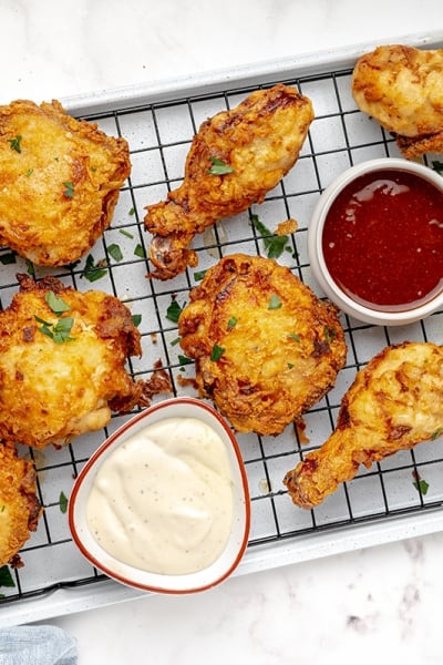 buttermilk fried chicken on wire rack with hot sauce tilted