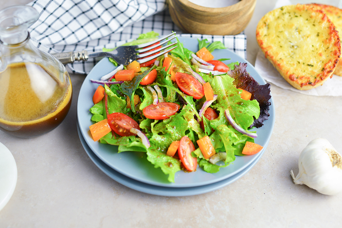 overhead shot of green salad on a blue plate