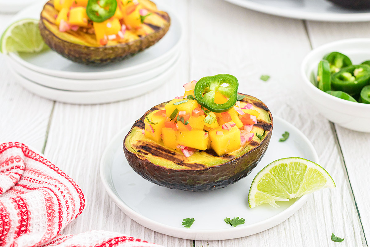 grilled avocado topped with chicken and tropical salsa 
