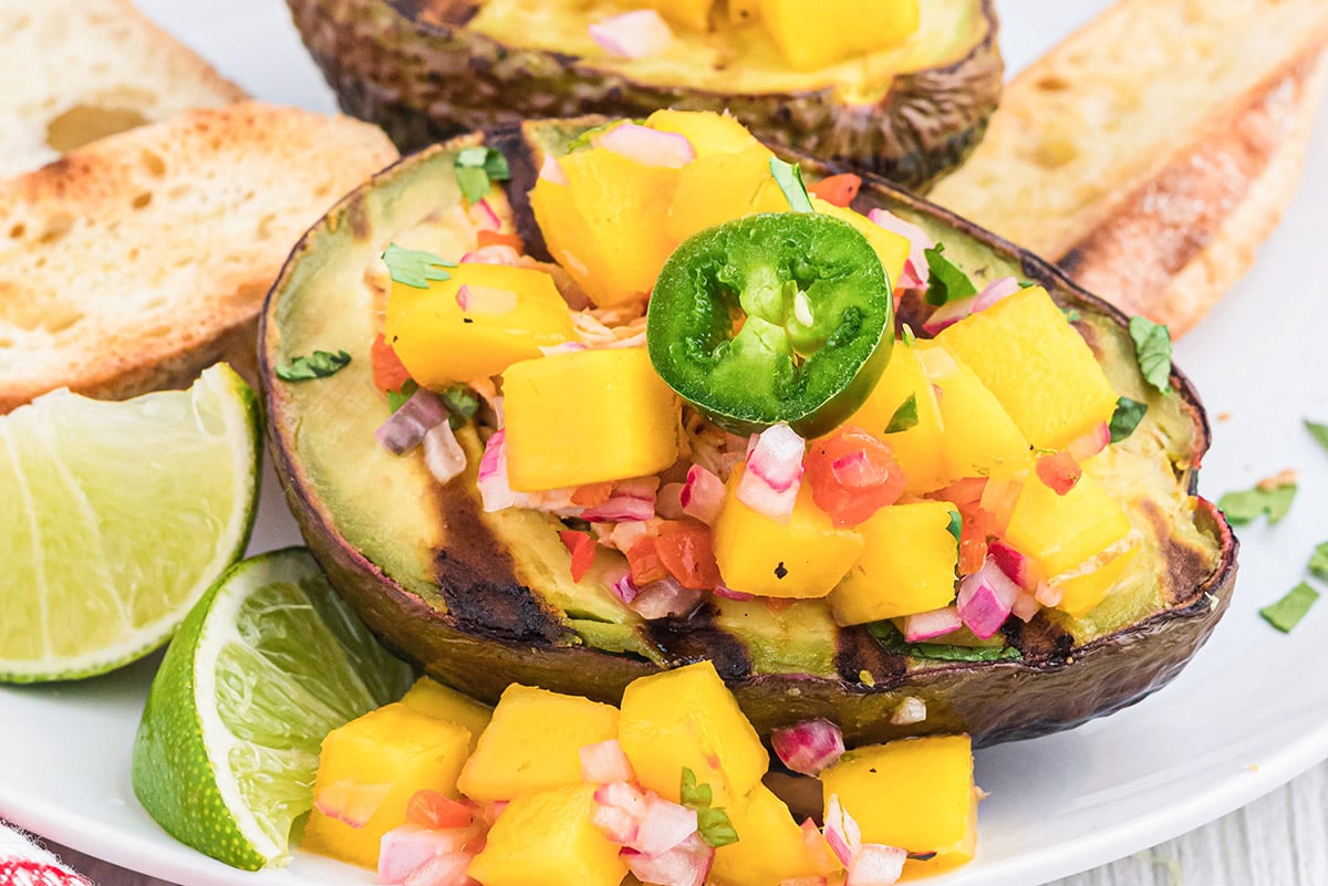close up of avocado with mango and fresh jalapeno slice 