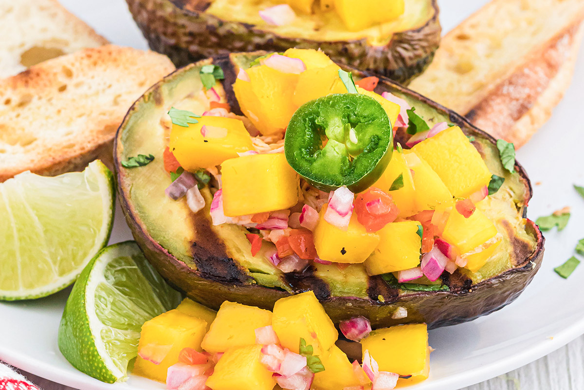 close up of grilled avocado stuffed with chicken