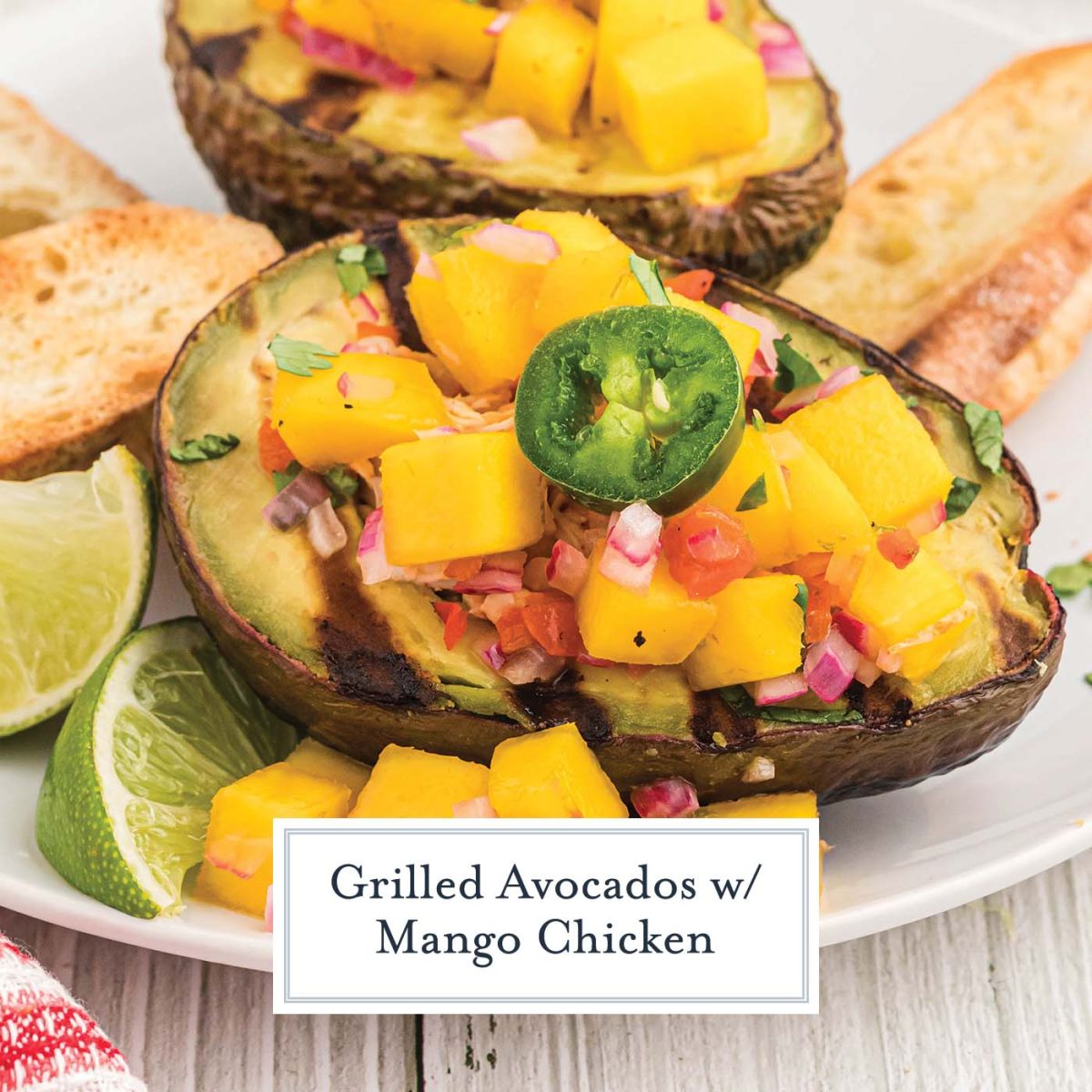 close up of grilled avocado half with chicken and mango salsa
