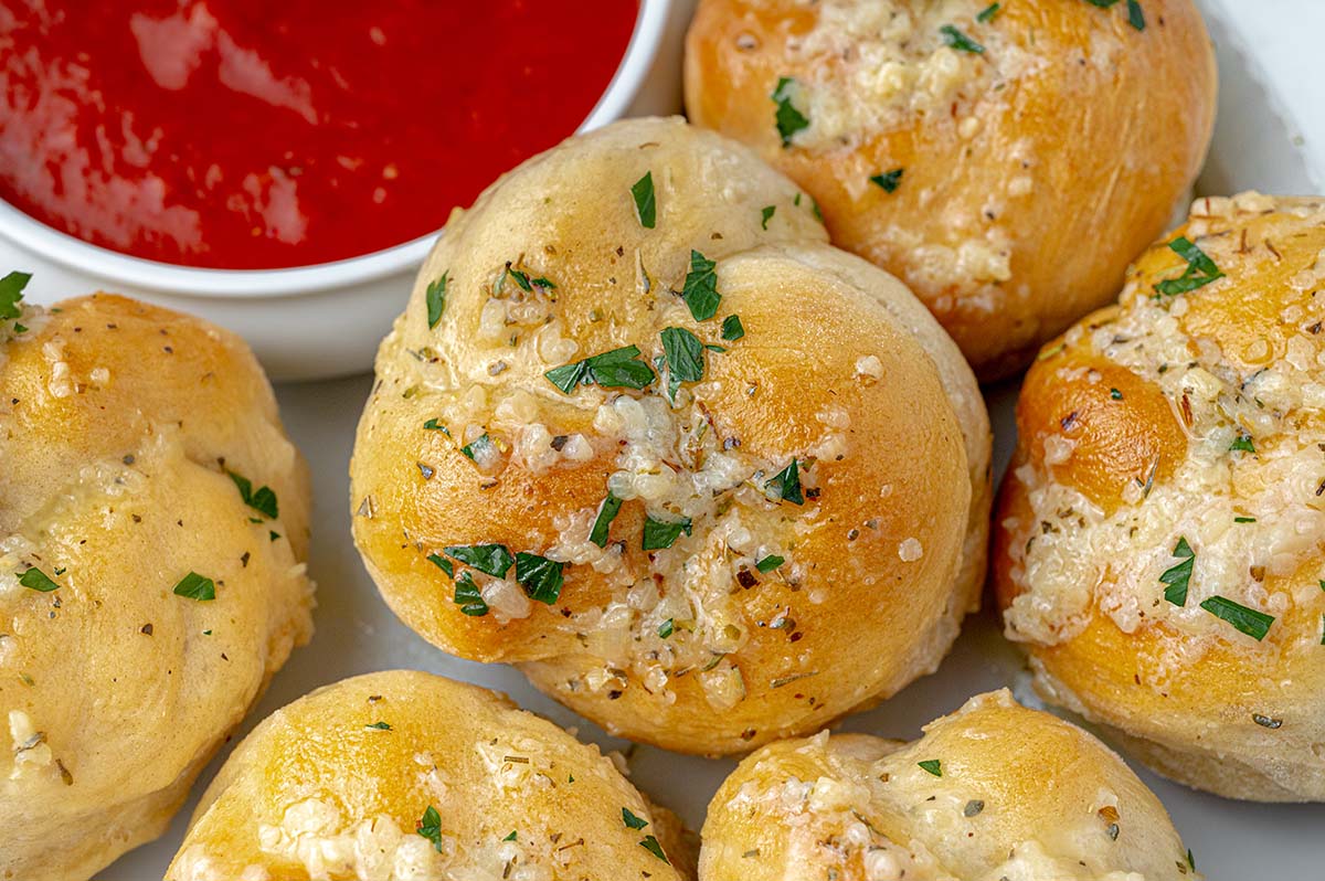 close up of a garlic knot topped with garlic butter 