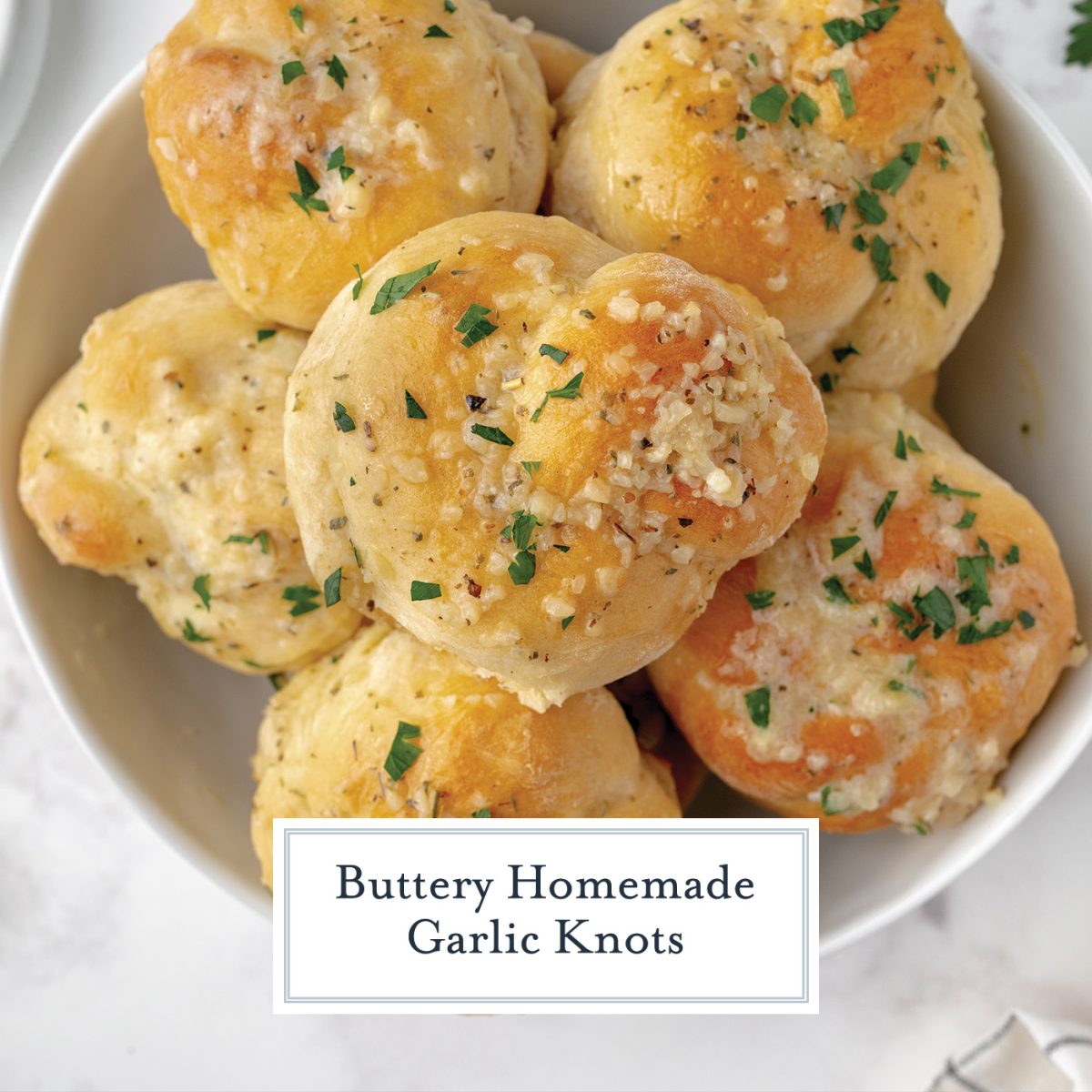 close up of yeast roll with chopped garlic and butter