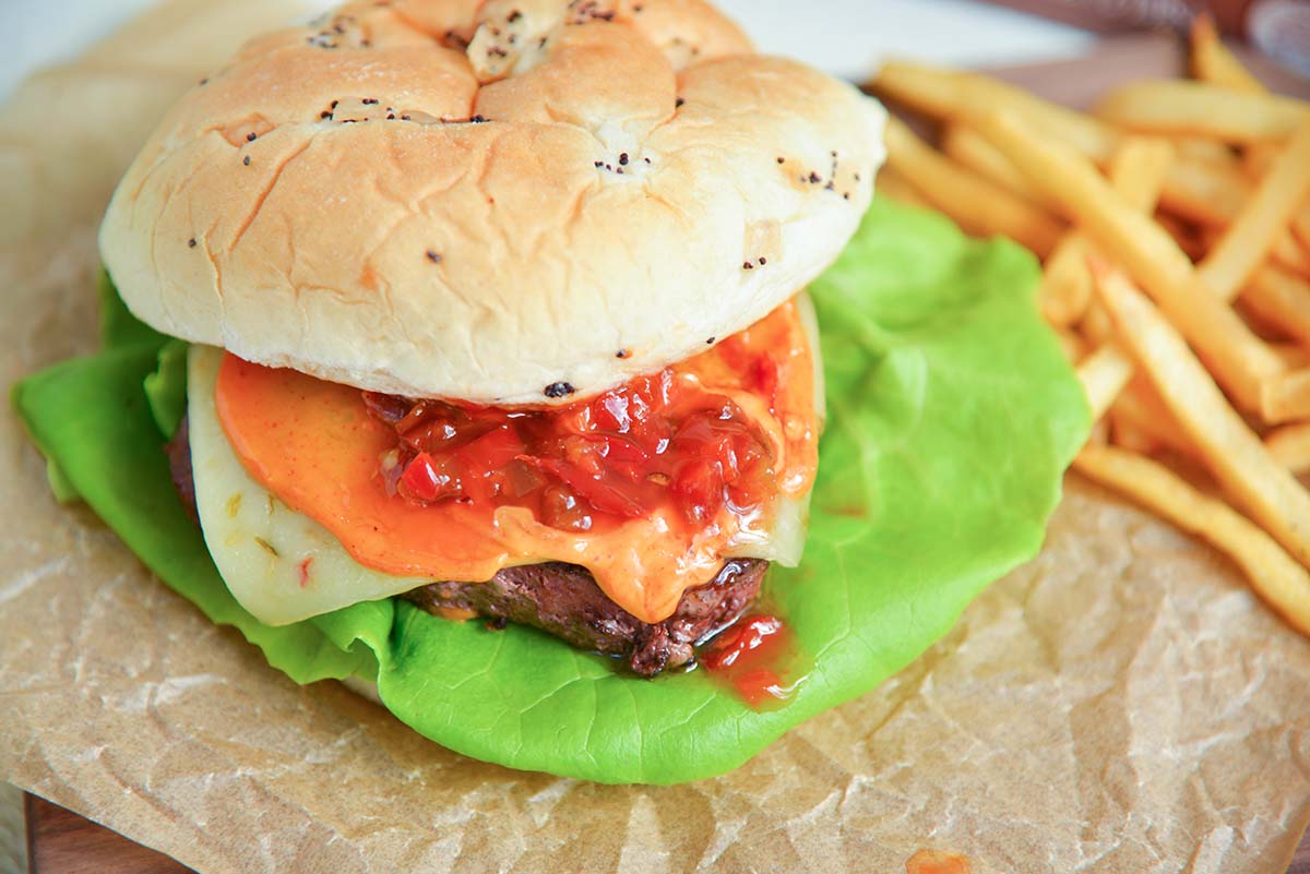 angle of burger with pepper spread, spicy mayo and lettuce