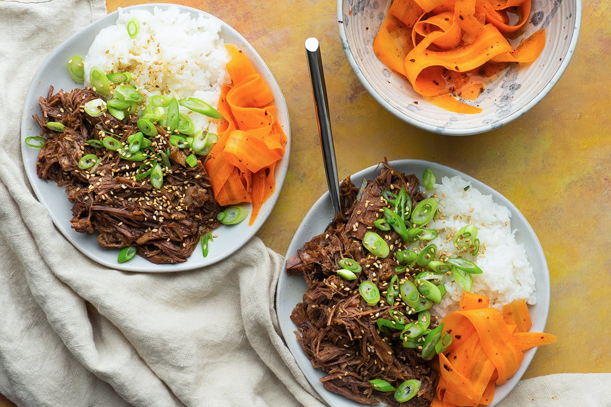 overhead shot of two bowl of korean beef barbecue with spoon