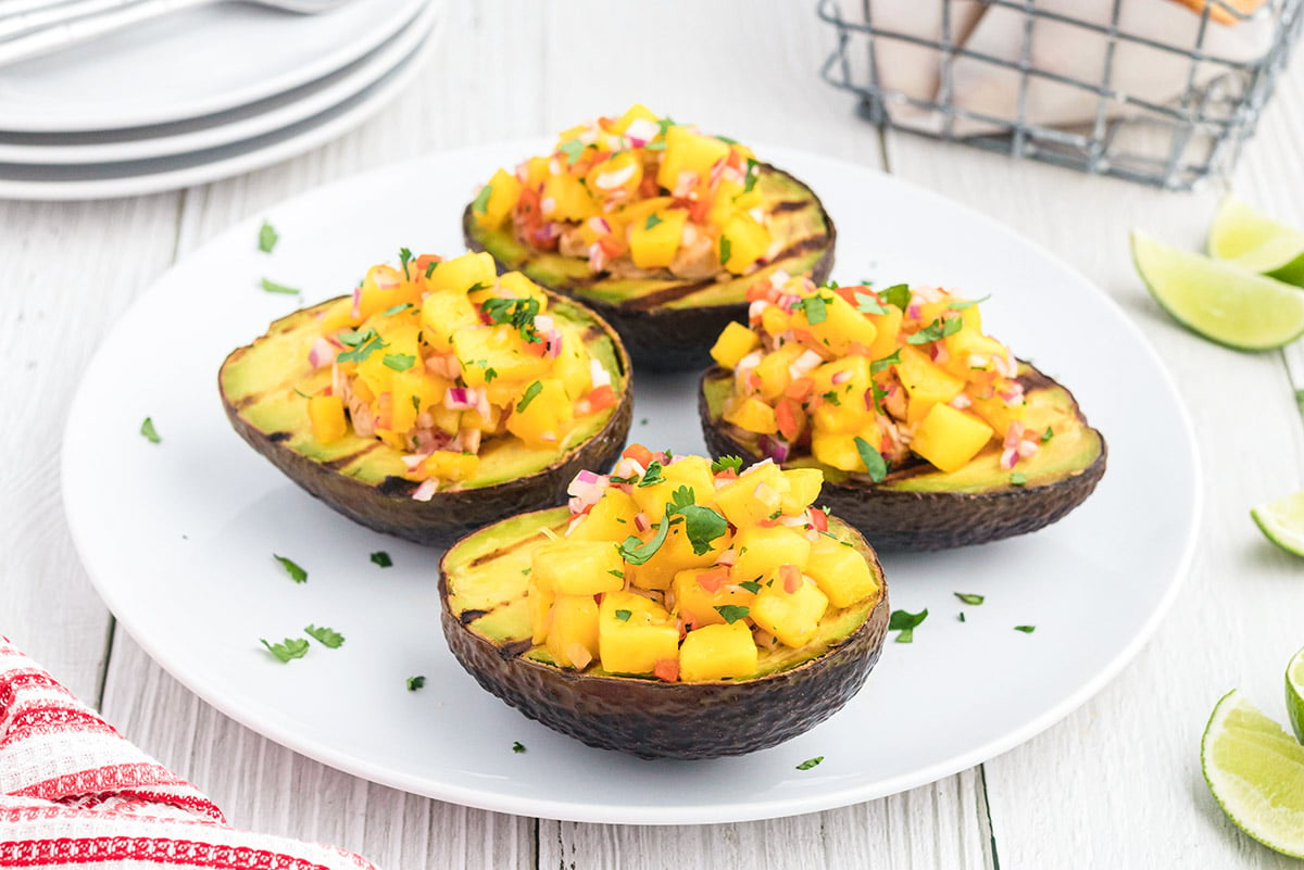 angle view of grilled avocados topped with mango salsa