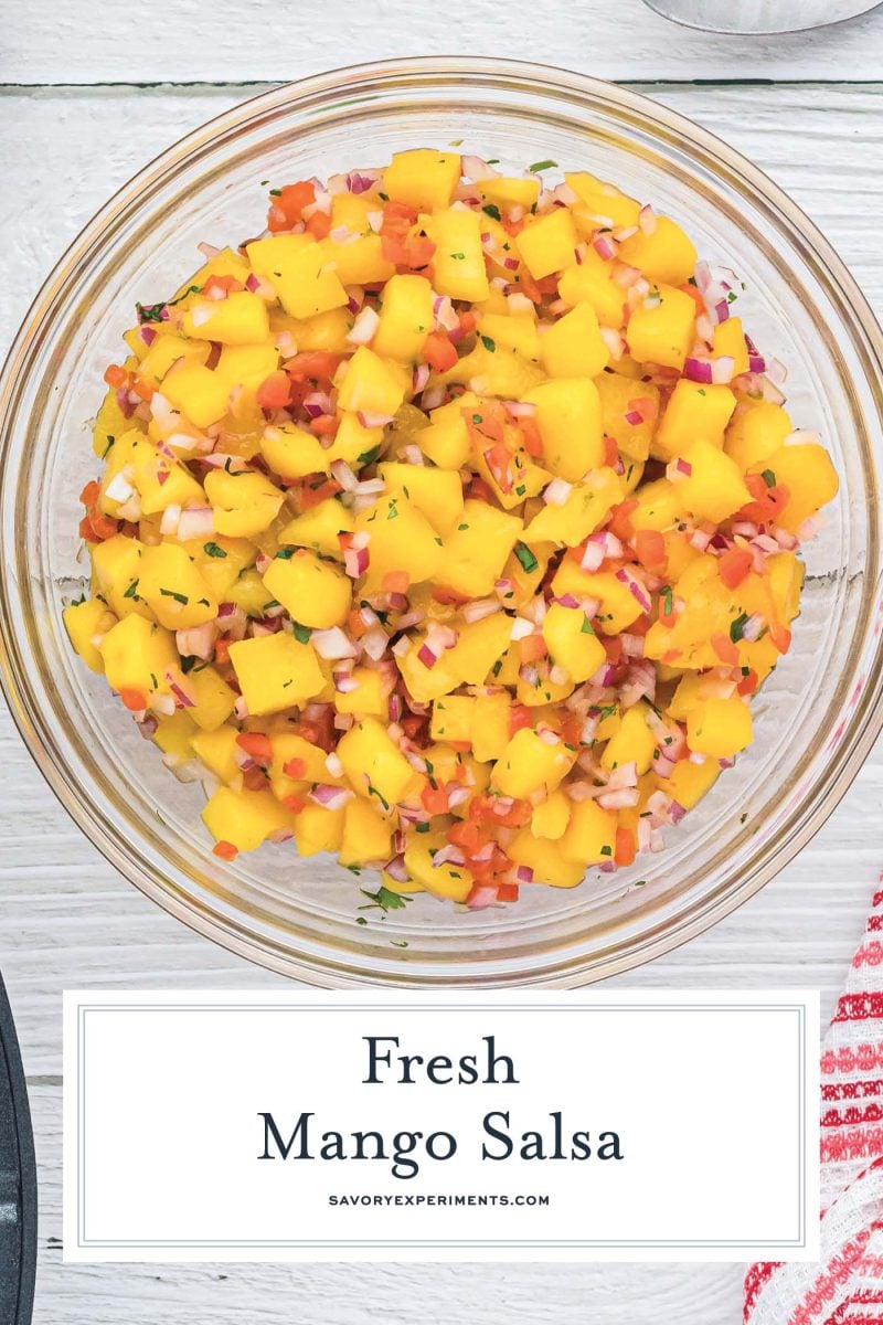 close up of fresh mango salsa in a glass mixing bowl 