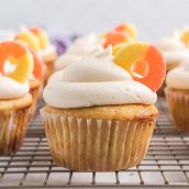 peach cupcakes on a wire cooling rack