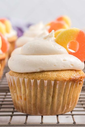 peach cupcakes on a wire cooling rack
