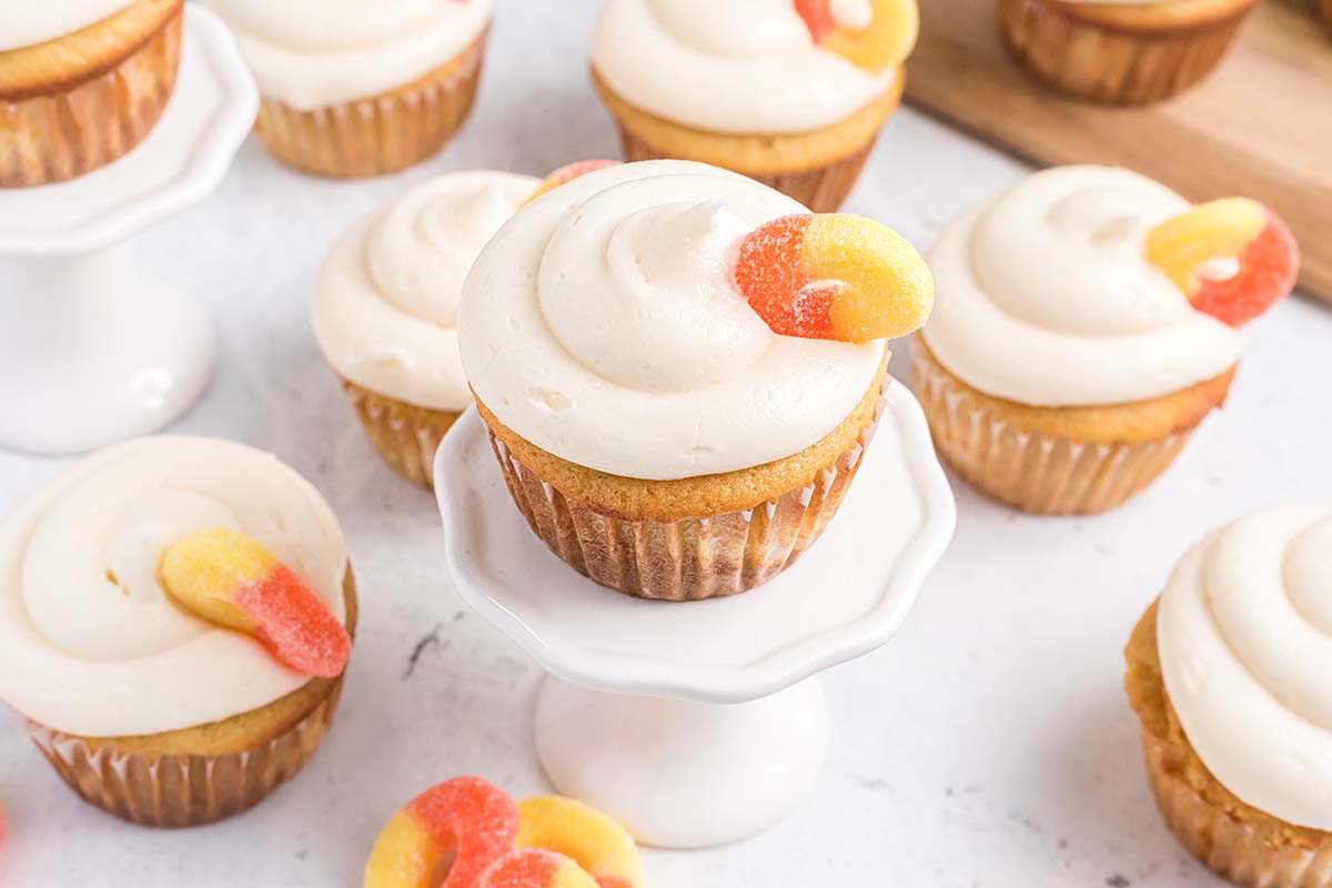 angle view of peach cupcake on a cupcake stand 