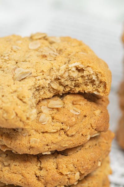 stack of peanut butter oatmeal cookies with bite taken out of top one