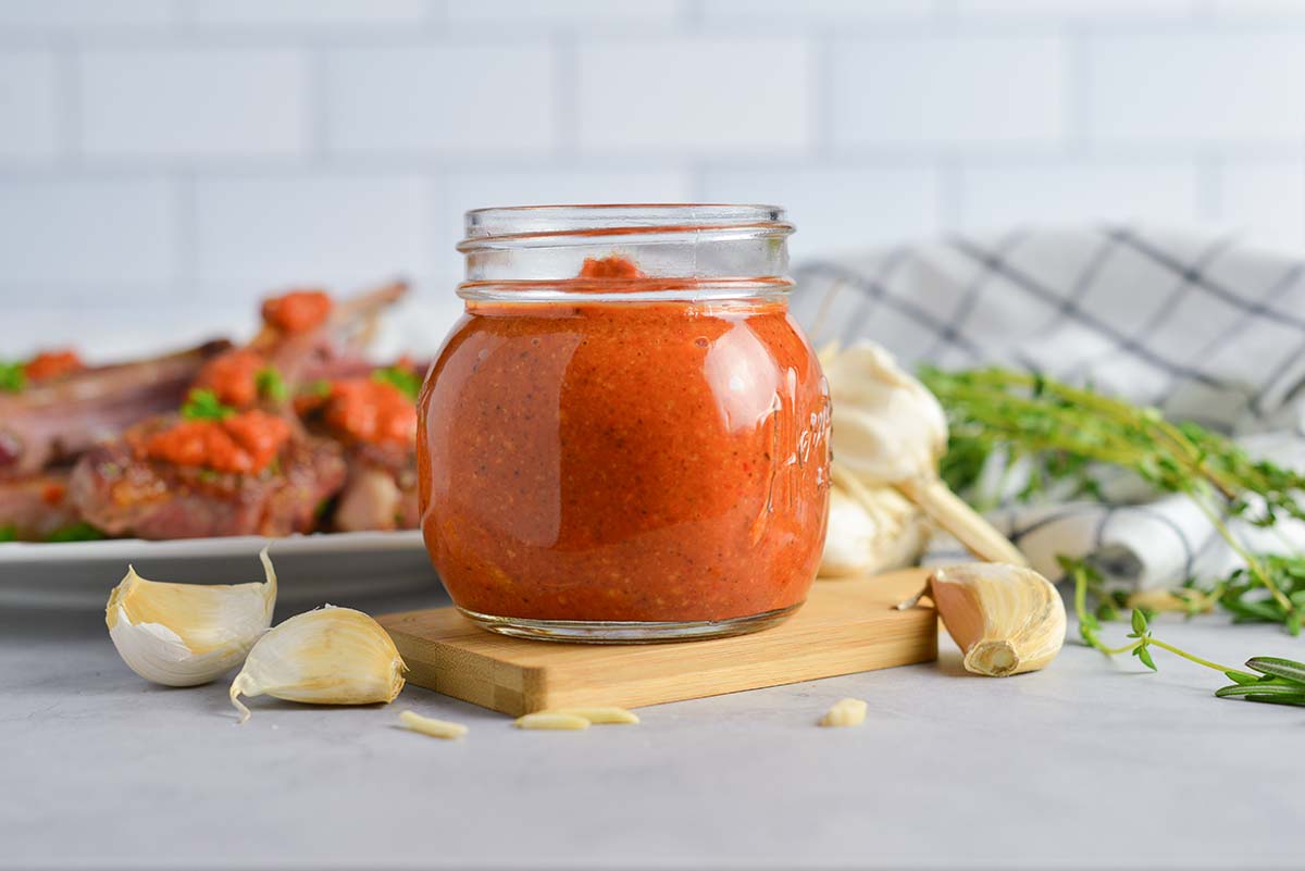 head on view of homemade romesco in a glass jar 