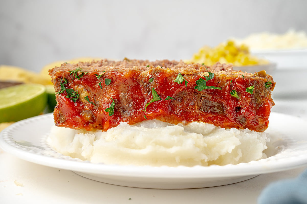 head on shot of slice of southwest meatloaf over mashed potatoes