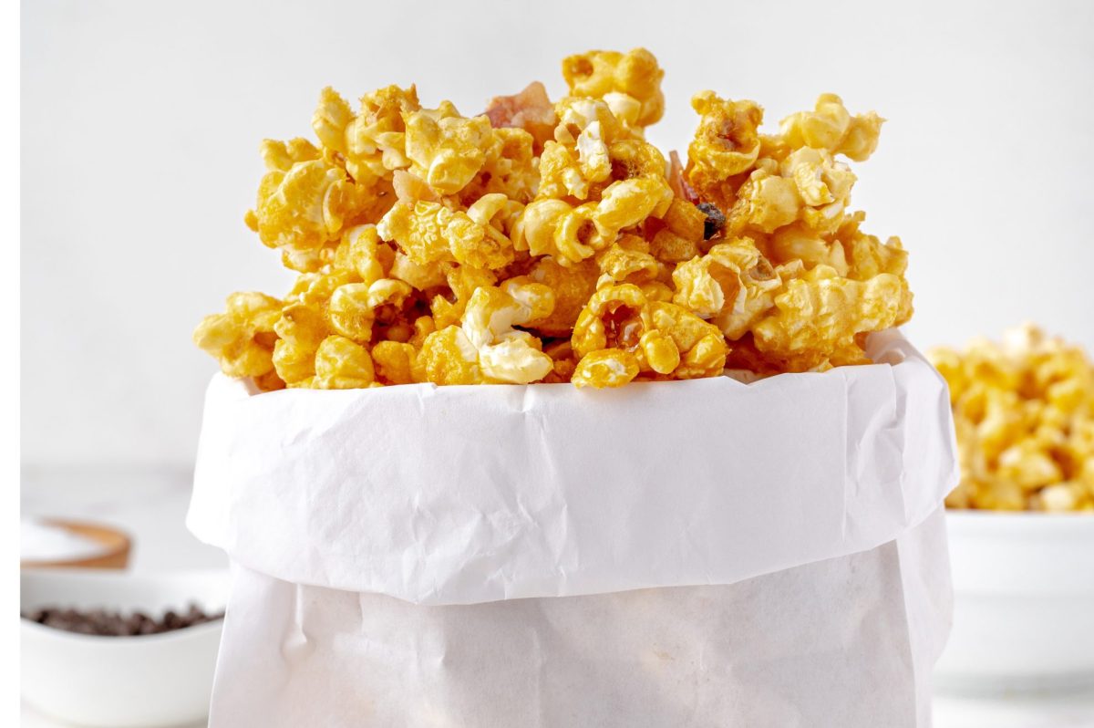 straight shot of bacon caramel popcorn in white paper bag