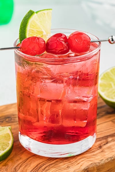 dirty shirley on a cutting board with limes